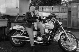 A black and white self motorbike portrait photo of photographer Donna Powell and her daughter. A self photo taken by Donna from Donna May Photography.