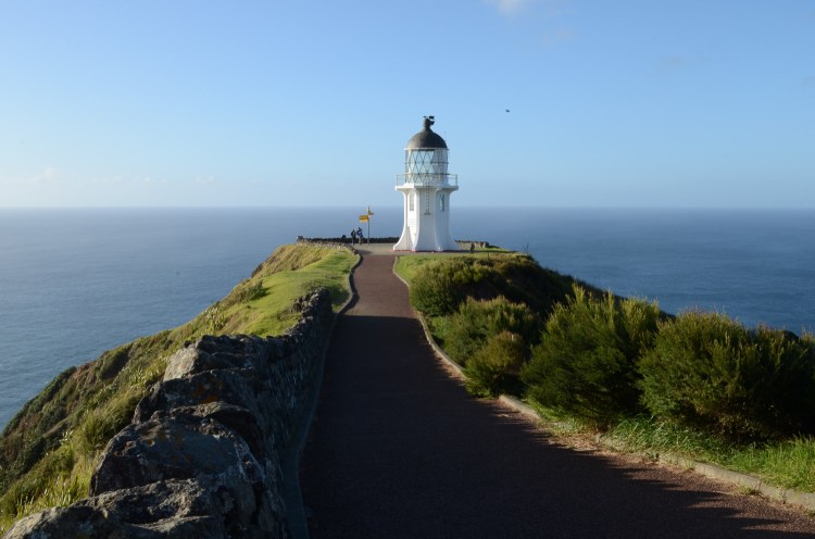 A landscape photo of Cape Reigna Lighthouse in the North Island of New Zealand
