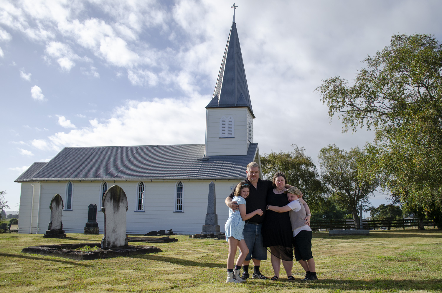 Family portrait photo in front of a church. Taken by Te Awamutu, Waikato based photographer, Donna from Donna May Photographer.