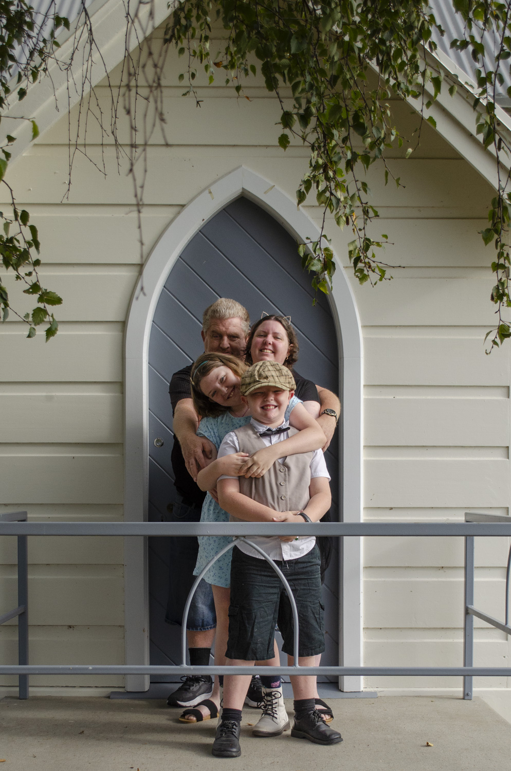 Family portrait photo in front of a church. Taken by Te Awamutu, Waikato based photographer, Donna from Donna May Photographer.