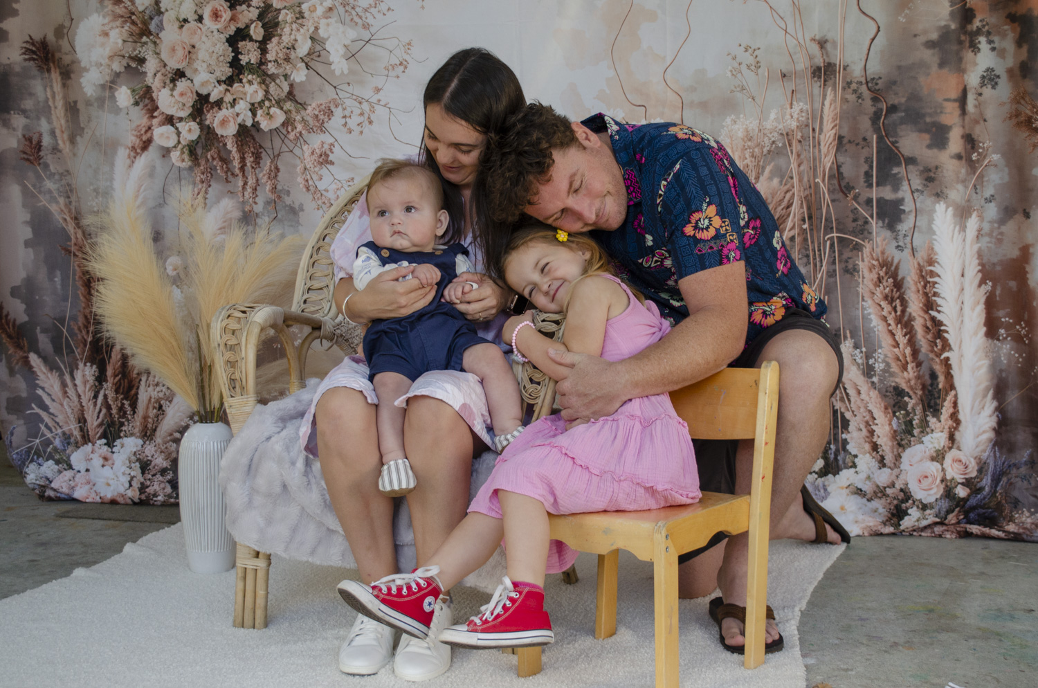 A lifestyle family portrait photo of a young family sharing an intimate moment. Taken by Te Awamutu, Waikato based photographer, Donna from Donna May Photography
