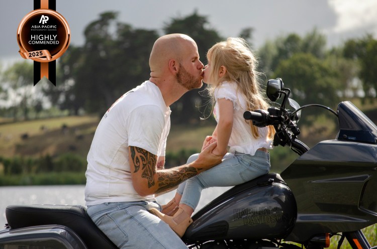 A motorbike family portrait photo of a dad and his daughter. Taken by Te Awamutu, Waikato based photographer Donna from Donna May photography. This photo was highly commended in the 2025 Asia Pacific Awards.