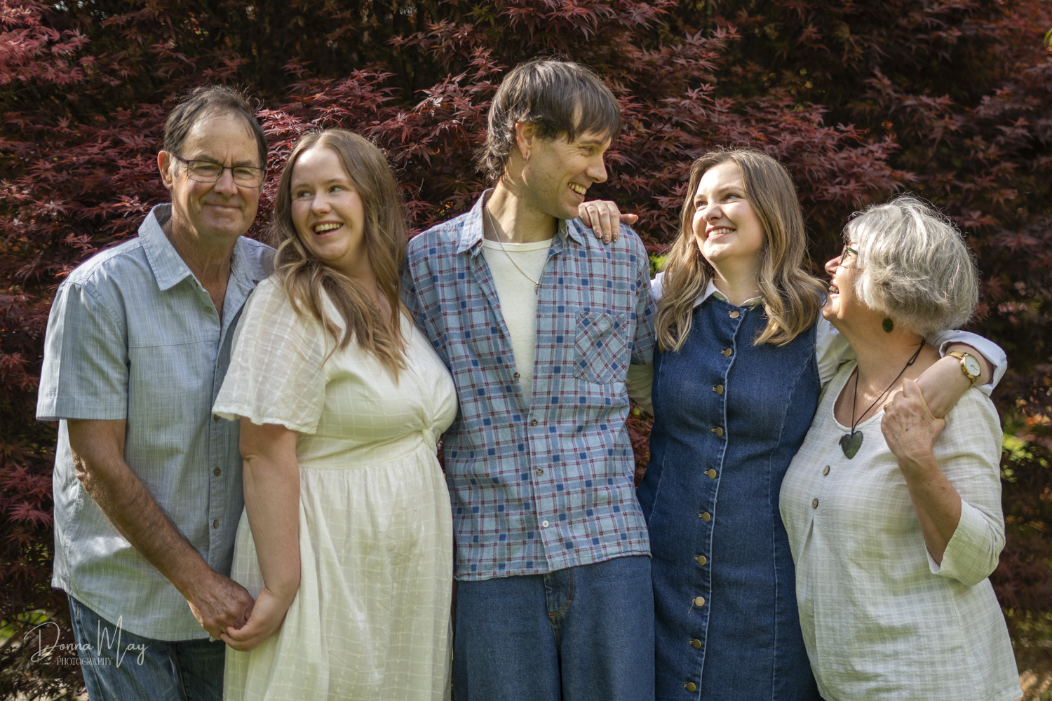 A family portrait of a mum and dad with their grown up children, Taken by Te Awamutu, Waikato based photographer, Donna from Donna May Photography.