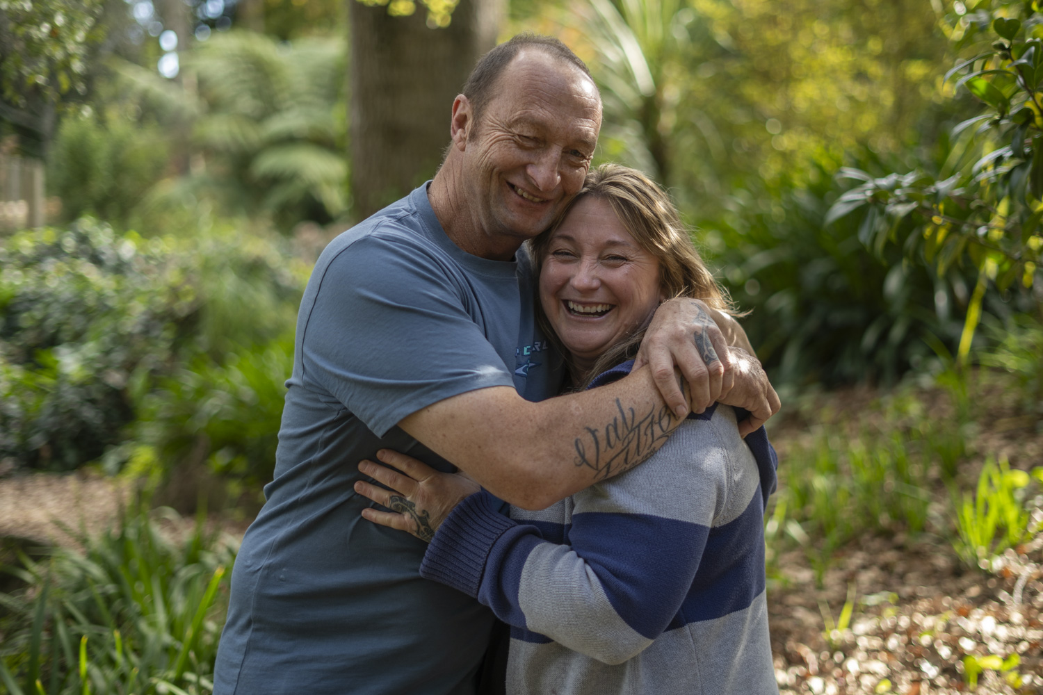 A portrait photo of a couple holding each other in a park in autumn. Taken by Te Awamutu, Waikato based photographer, Donna from Donna May Photography